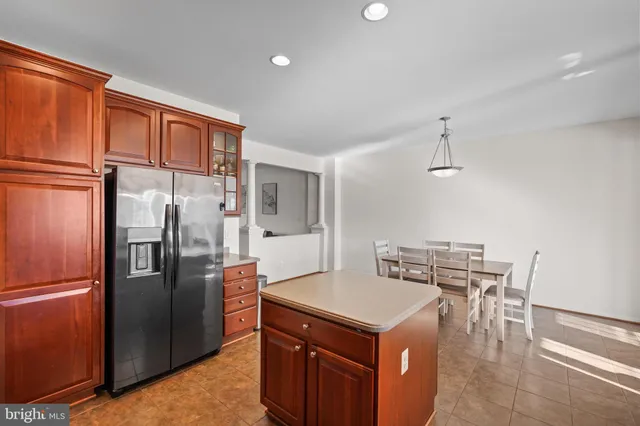 a kitchen with stainless steel appliances granite countertop a refrigerator a stove and a sink