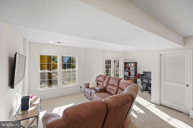 a living room with furniture window and a flat screen tv