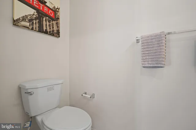 a white toilet sitting next to a shower