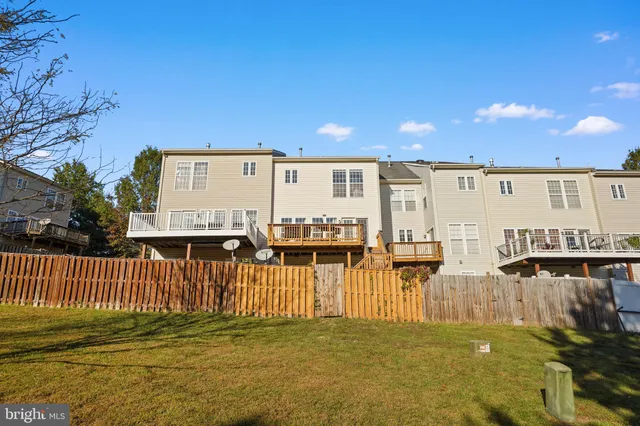 a view of a house with backyard and deck