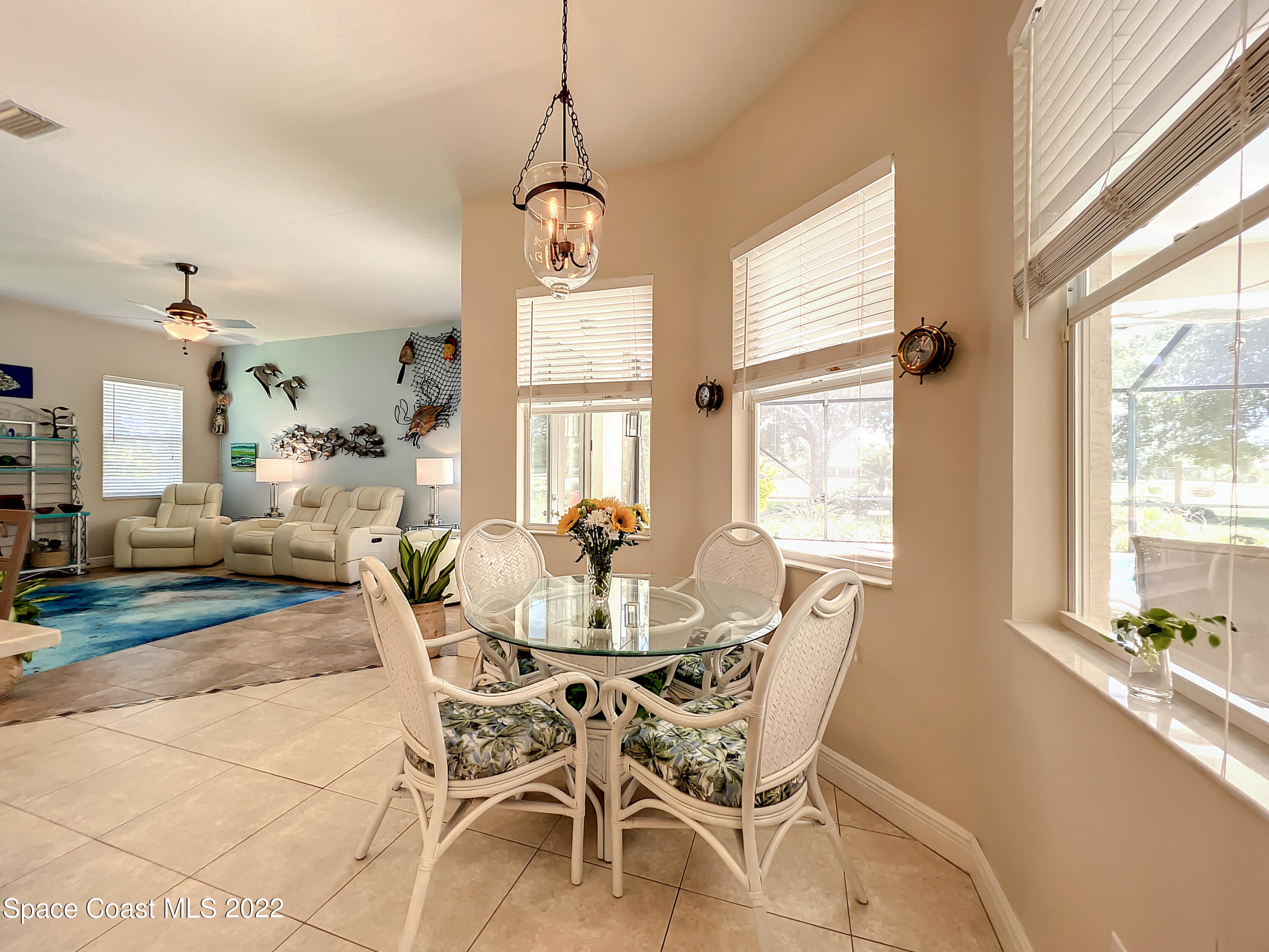 1705 Winding Ridge Circle Southeast Palm Bay, FL 32909 - Photo 14 of 45 a view of a dining room with furniture windows and wooden floor
