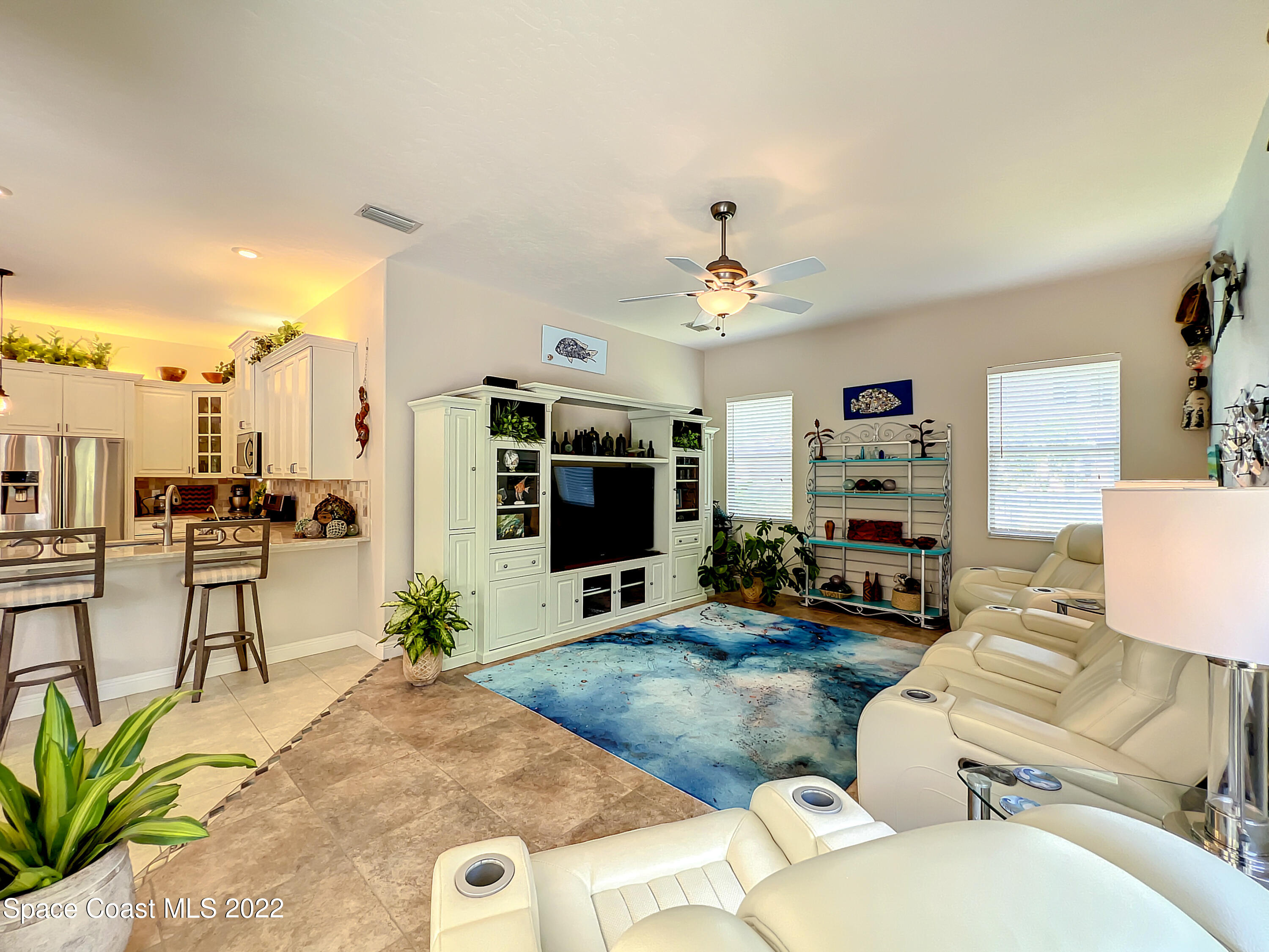1705 Winding Ridge Circle Southeast Palm Bay, FL 32909 - Photo 15 of 45 a living room with furniture and a flat screen tv