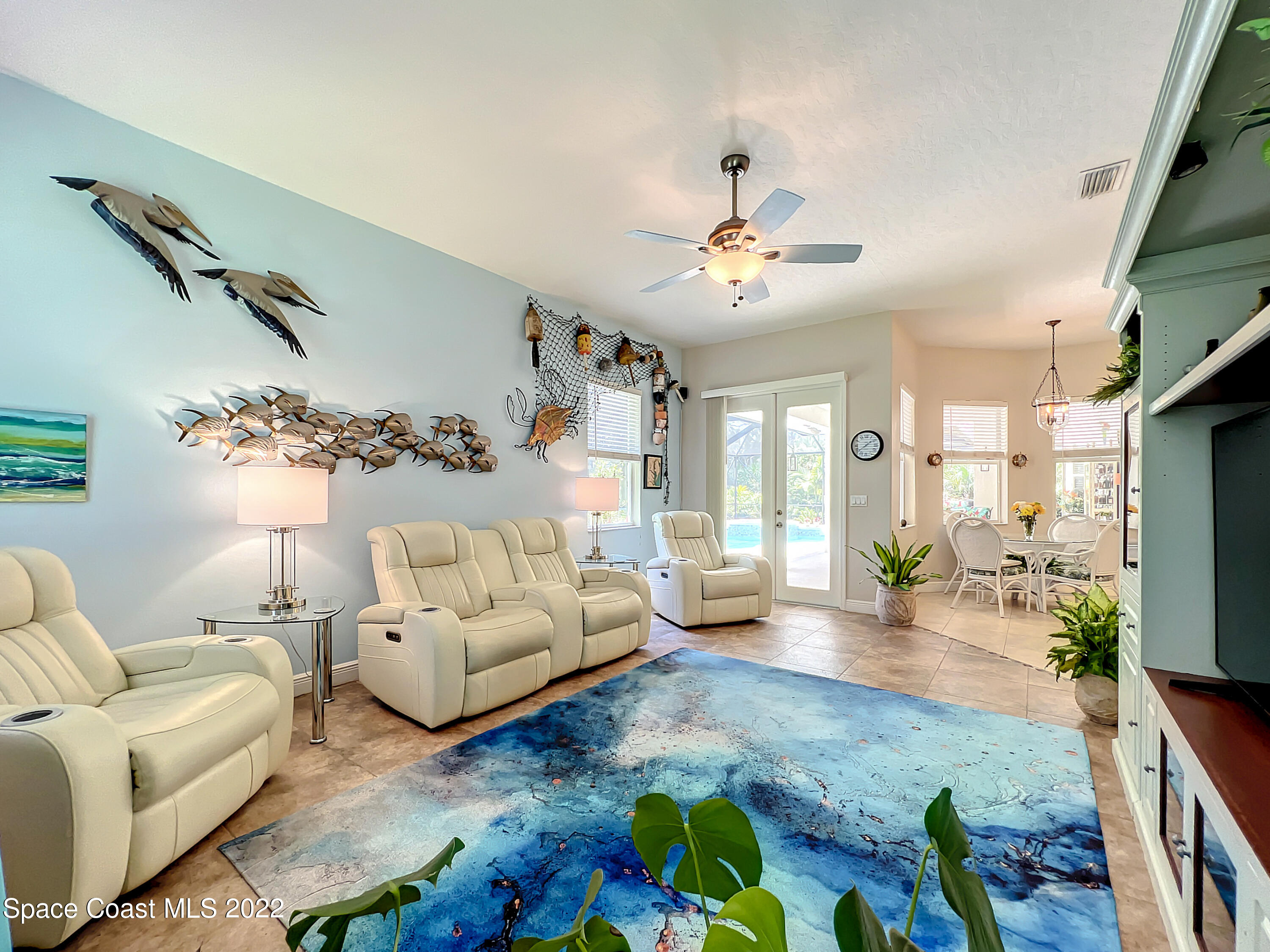 1705 Winding Ridge Circle Southeast Palm Bay, FL 32909 - Photo 17 of 45 a living room with furniture or couch and a flat screen tv
