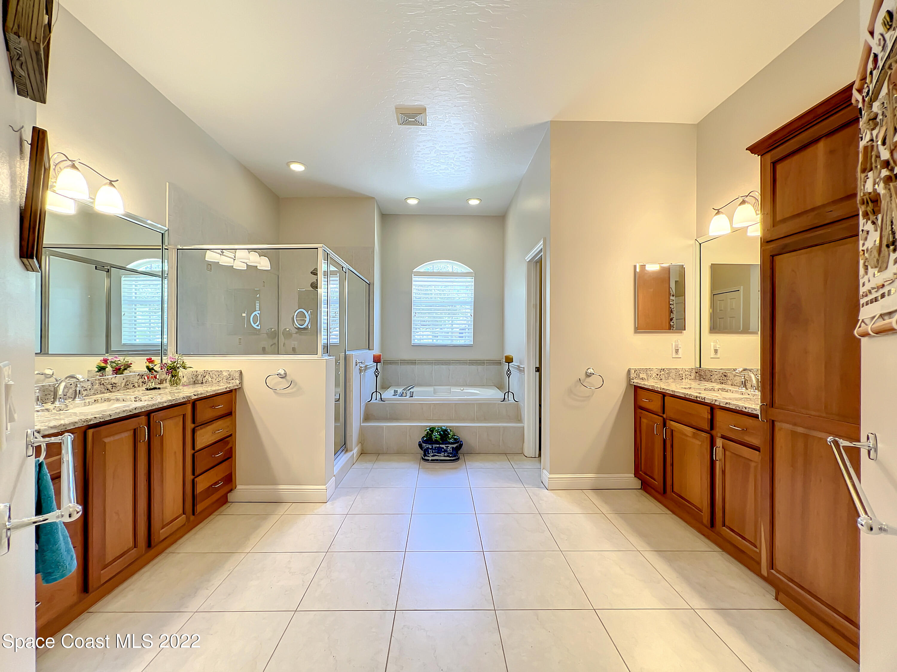 1705 Winding Ridge Circle Southeast Palm Bay, FL 32909 - Photo 20 of 45 a large kitchen with stainless steel appliances a stove a sink dishwasher and cabinets with wooden floor
