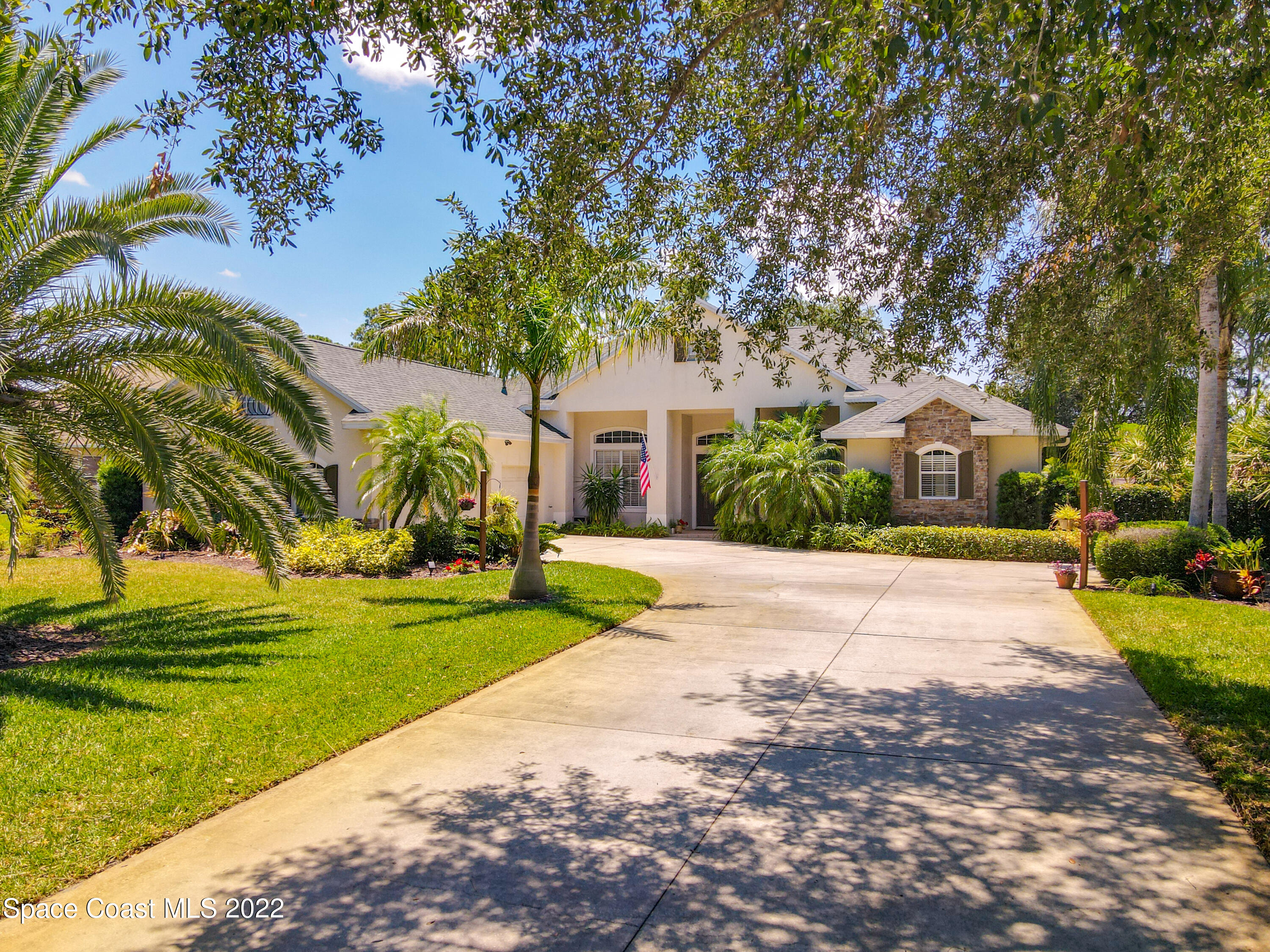 1705 Winding Ridge Circle Southeast Palm Bay, FL 32909 - Photo 2 of 45 a front view of a house with a yard and trees