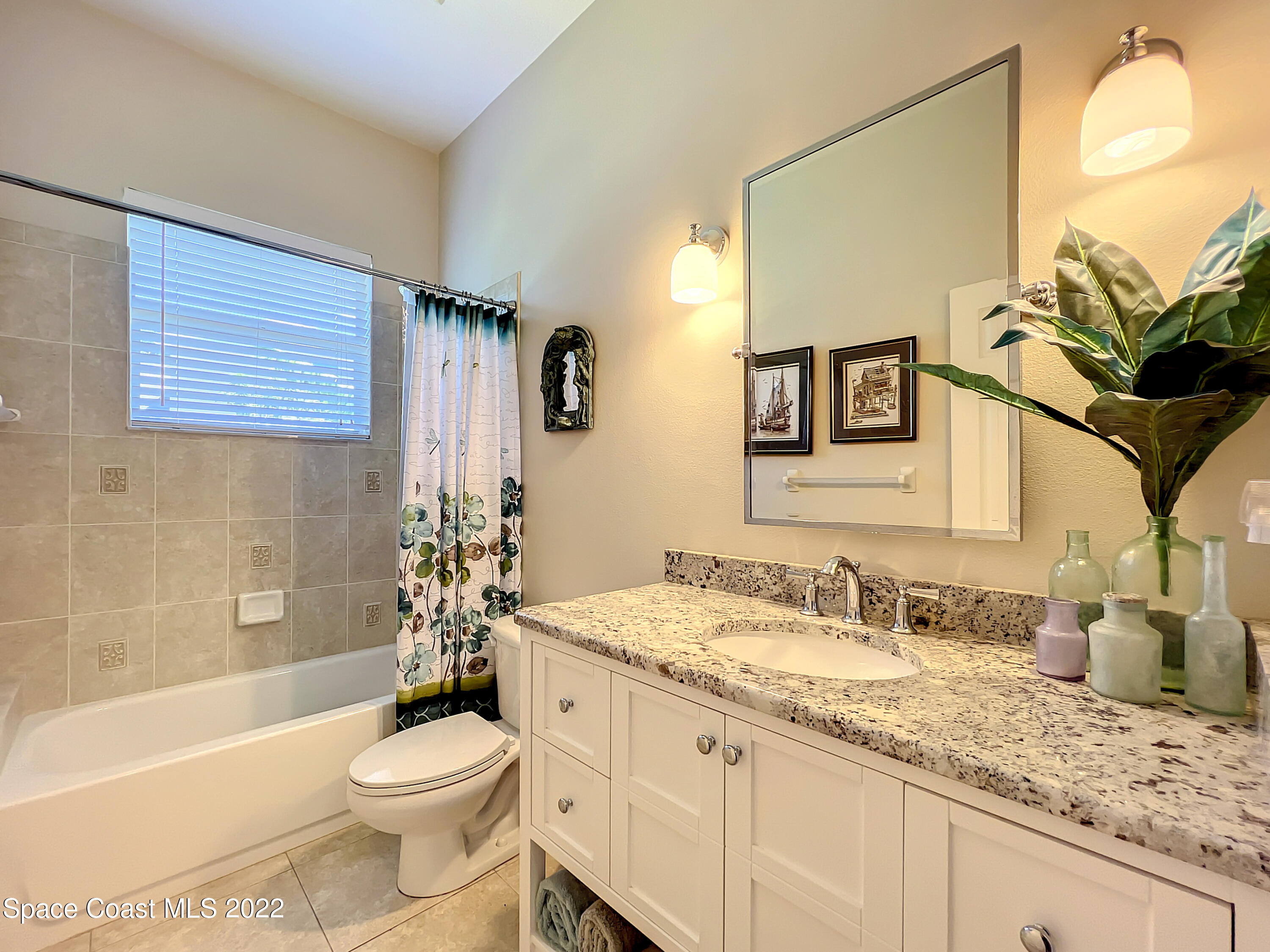 1705 Winding Ridge Circle Southeast Palm Bay, FL 32909 - Photo 26 of 45 a bathroom with a granite countertop sink toilet and shower