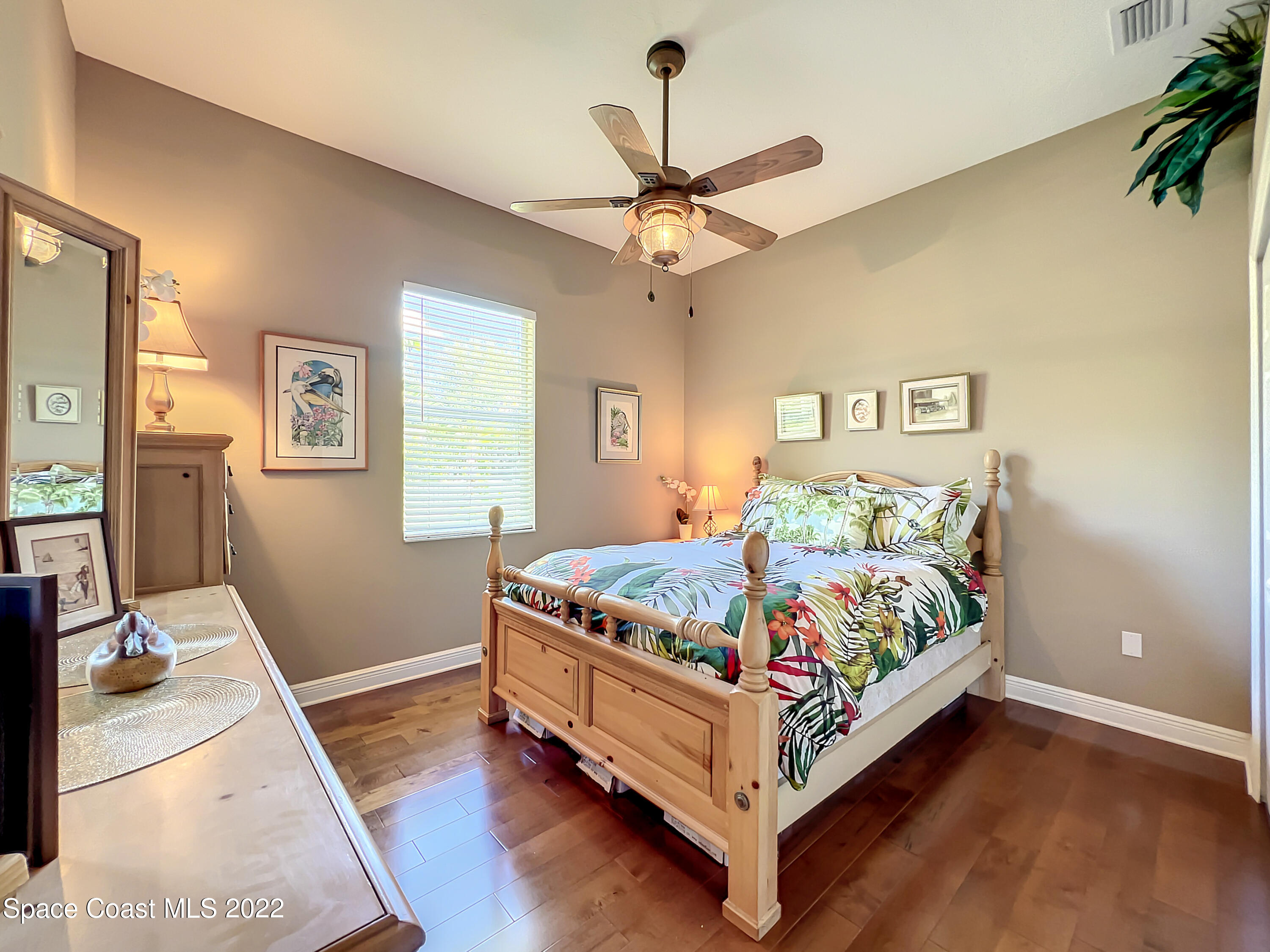1705 Winding Ridge Circle Southeast Palm Bay, FL 32909 - Photo 27 of 45 a bed sitting in a bedroom next to a window