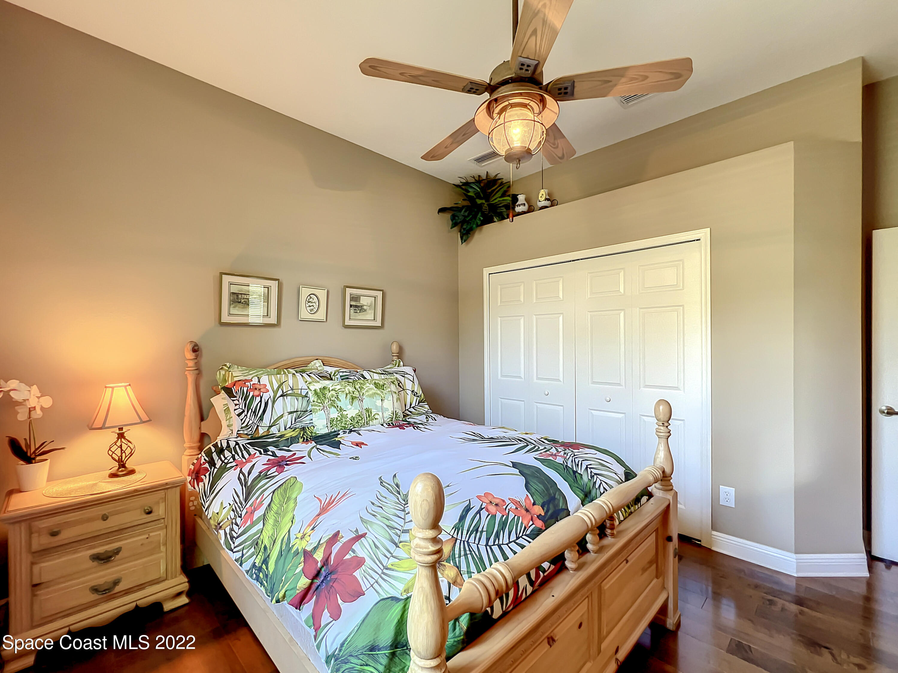 1705 Winding Ridge Circle Southeast Palm Bay, FL 32909 - Photo 28 of 45 a bedroom with a bed and a chandelier