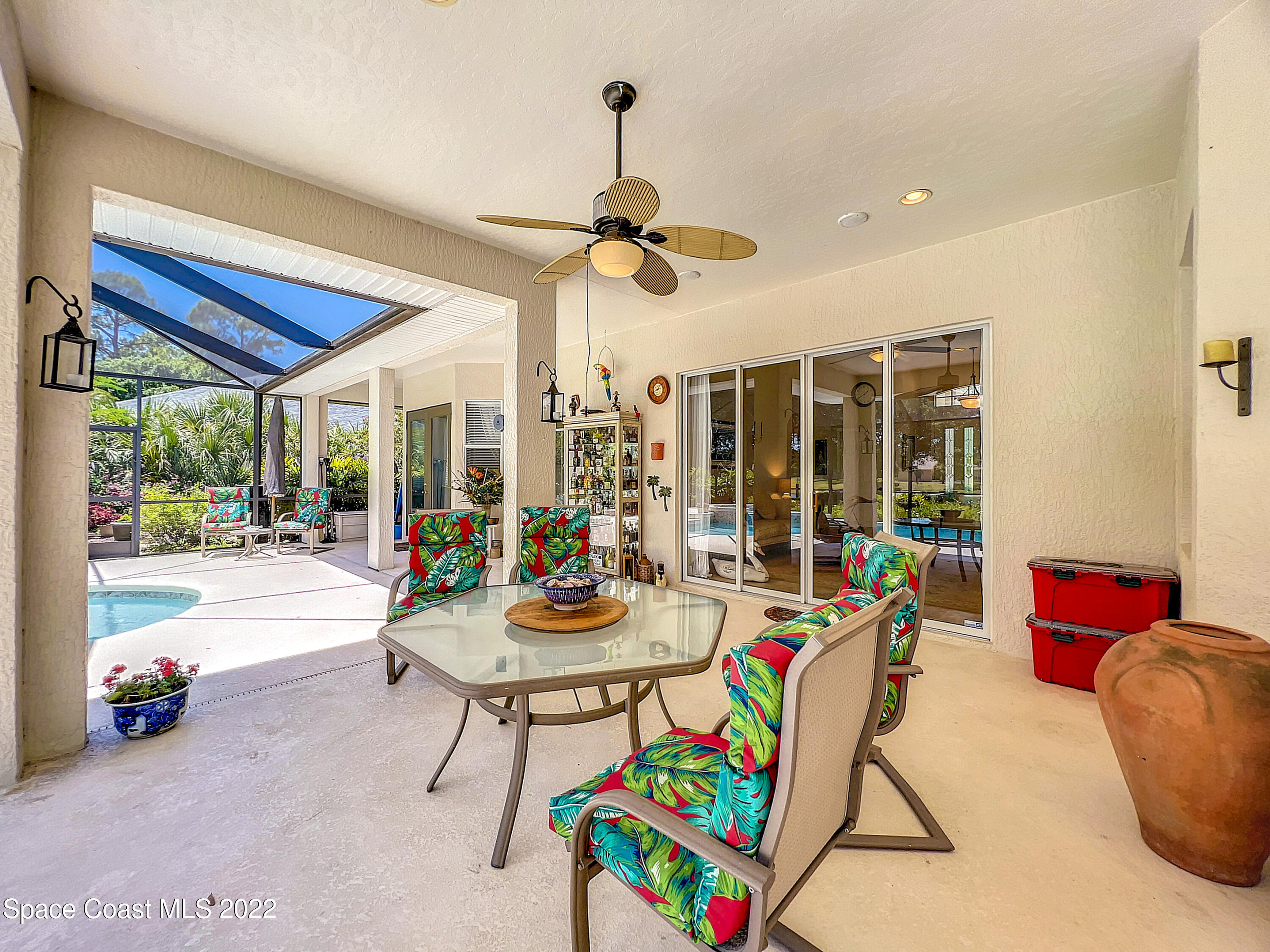 1705 Winding Ridge Circle Southeast Palm Bay, FL 32909 - Photo 31 of 45 a living room with furniture and a floor to ceiling window