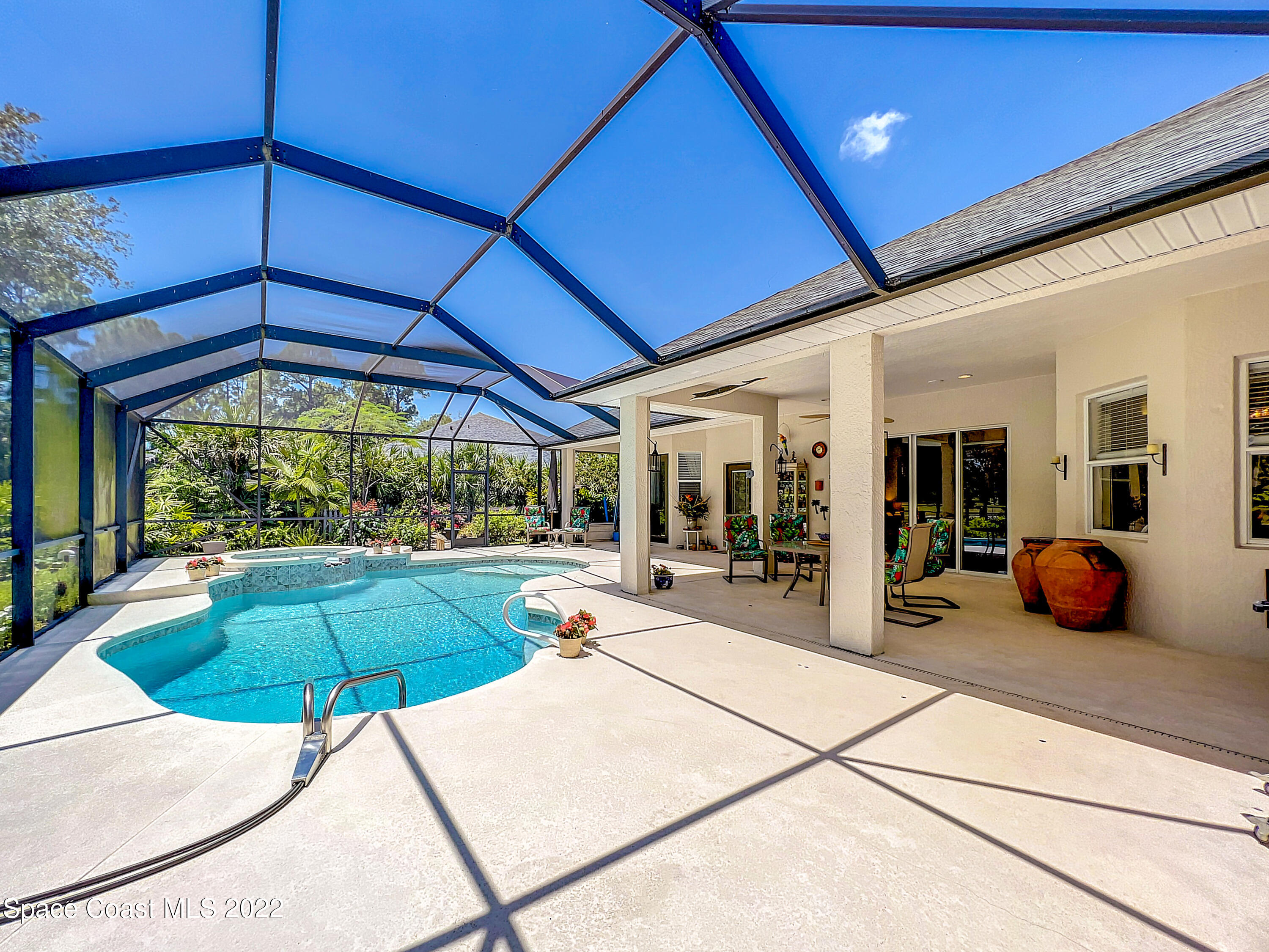 1705 Winding Ridge Circle Southeast Palm Bay, FL 32909 - Photo 34 of 45 a view of a patio with table and chairs under an umbrella