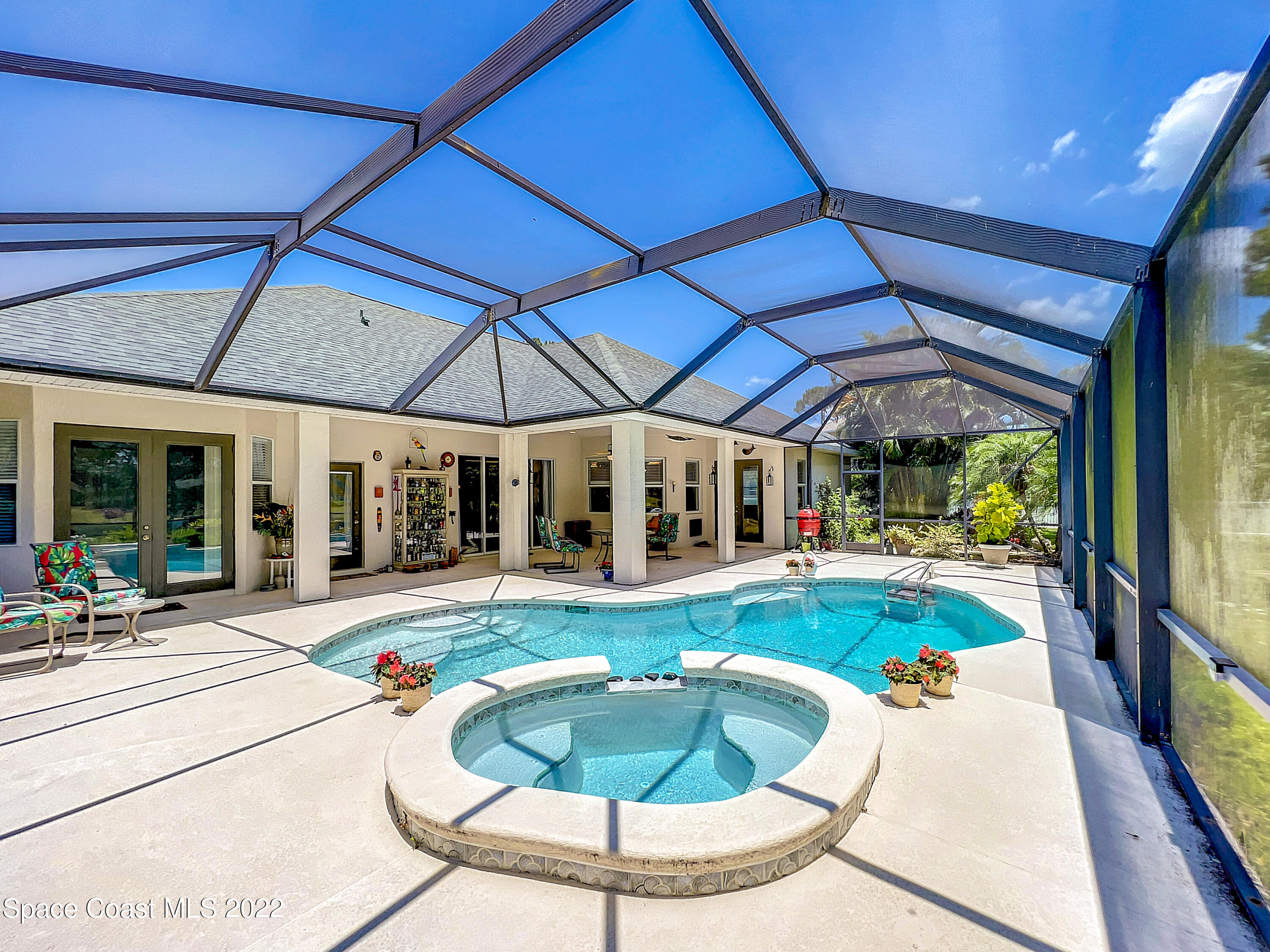 1705 Winding Ridge Circle Southeast Palm Bay, FL 32909 - Photo 36 of 45 a view of a house with swimming pool and sitting area