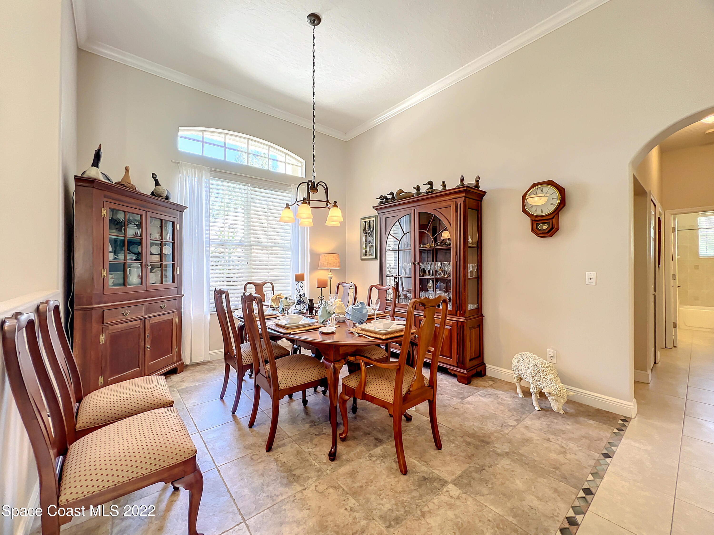 1705 Winding Ridge Circle Southeast Palm Bay, FL 32909 - Photo 5 of 45 a view of a dining room with furniture window and wooden floor