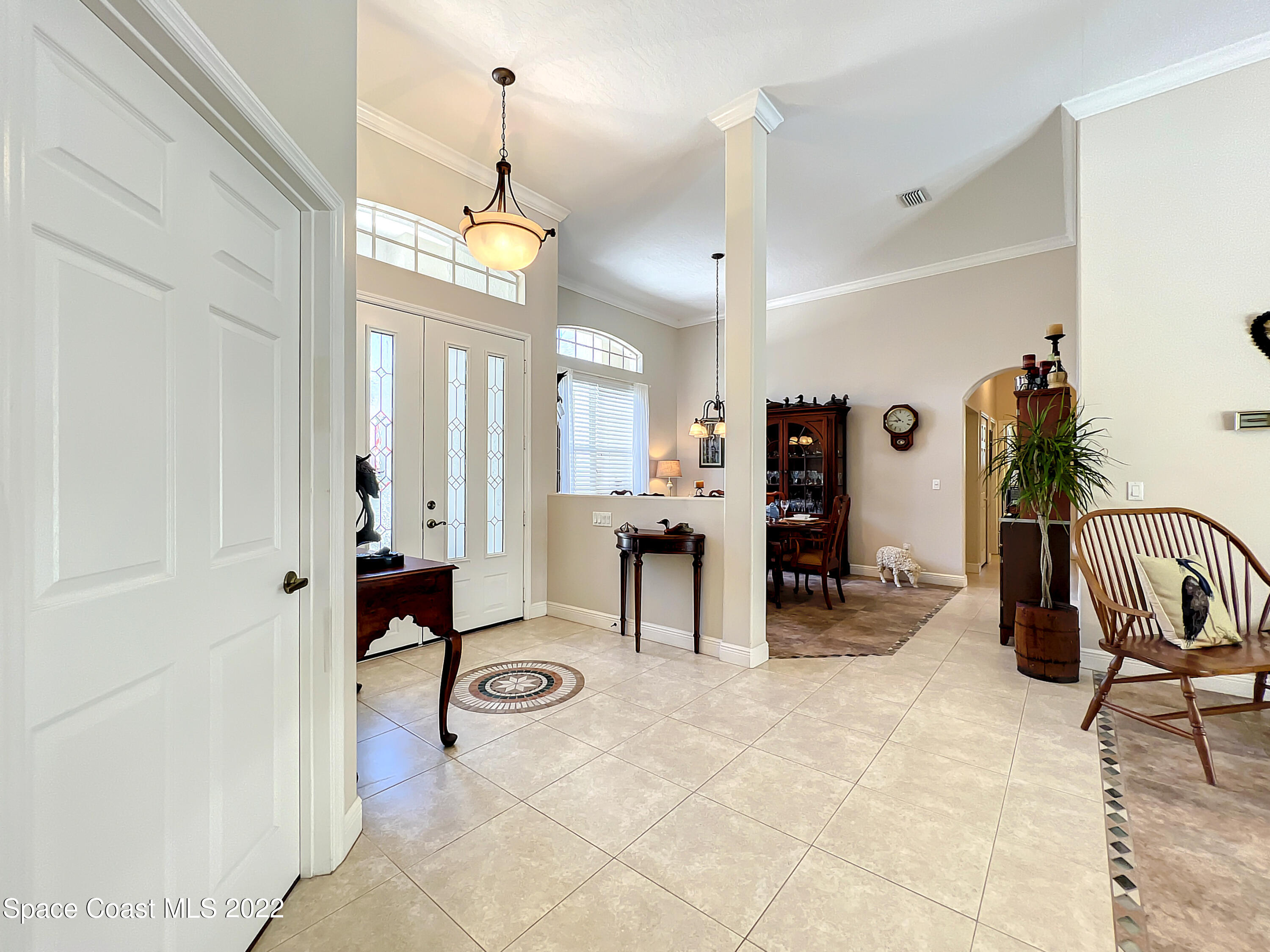 1705 Winding Ridge Circle Southeast Palm Bay, FL 32909 - Photo 6 of 45 a view of a livingroom with furniture and a chandelier