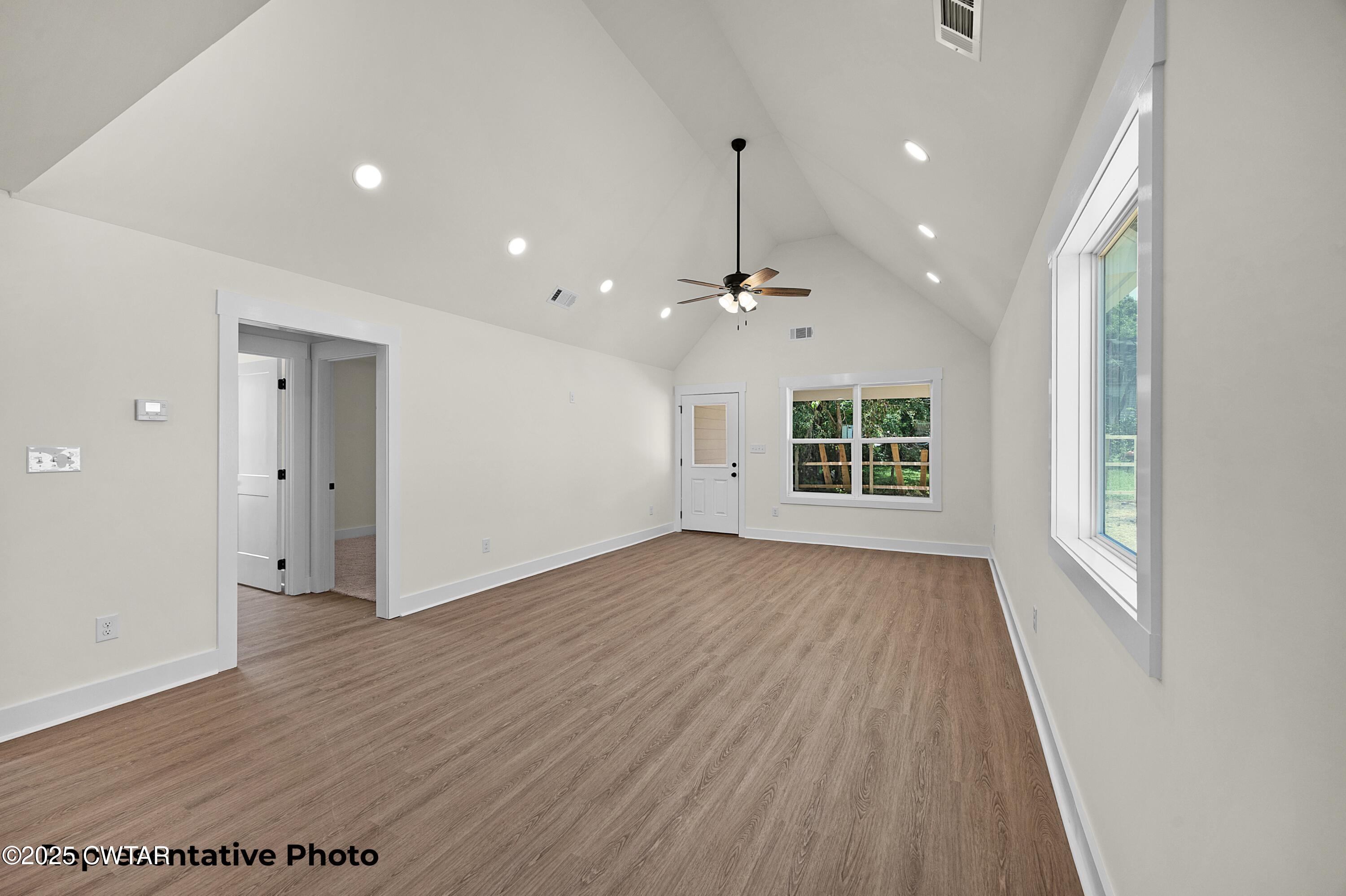 161 West Grand Street Jackson, TN 38301 - Photo 3 of 17 an empty room with wooden floor and windows