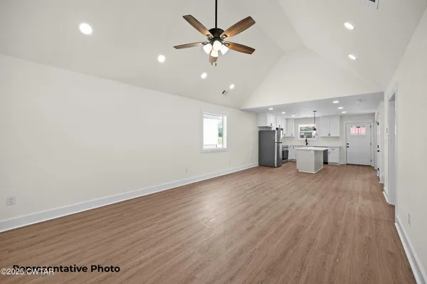 a large kitchen with a lot of counter space and refrigerator