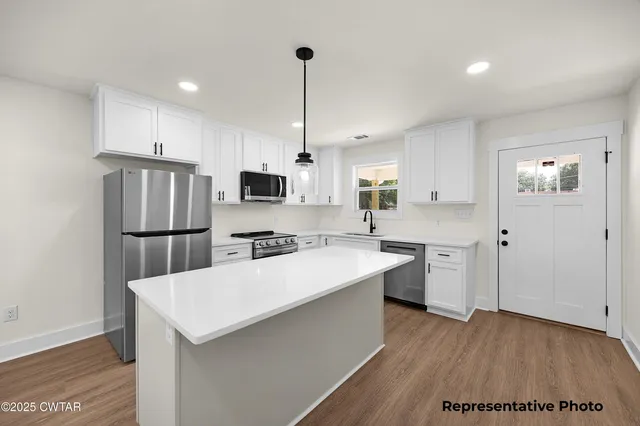 a large kitchen with cabinets