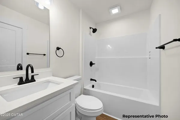 an empty room with ceiling fan and window