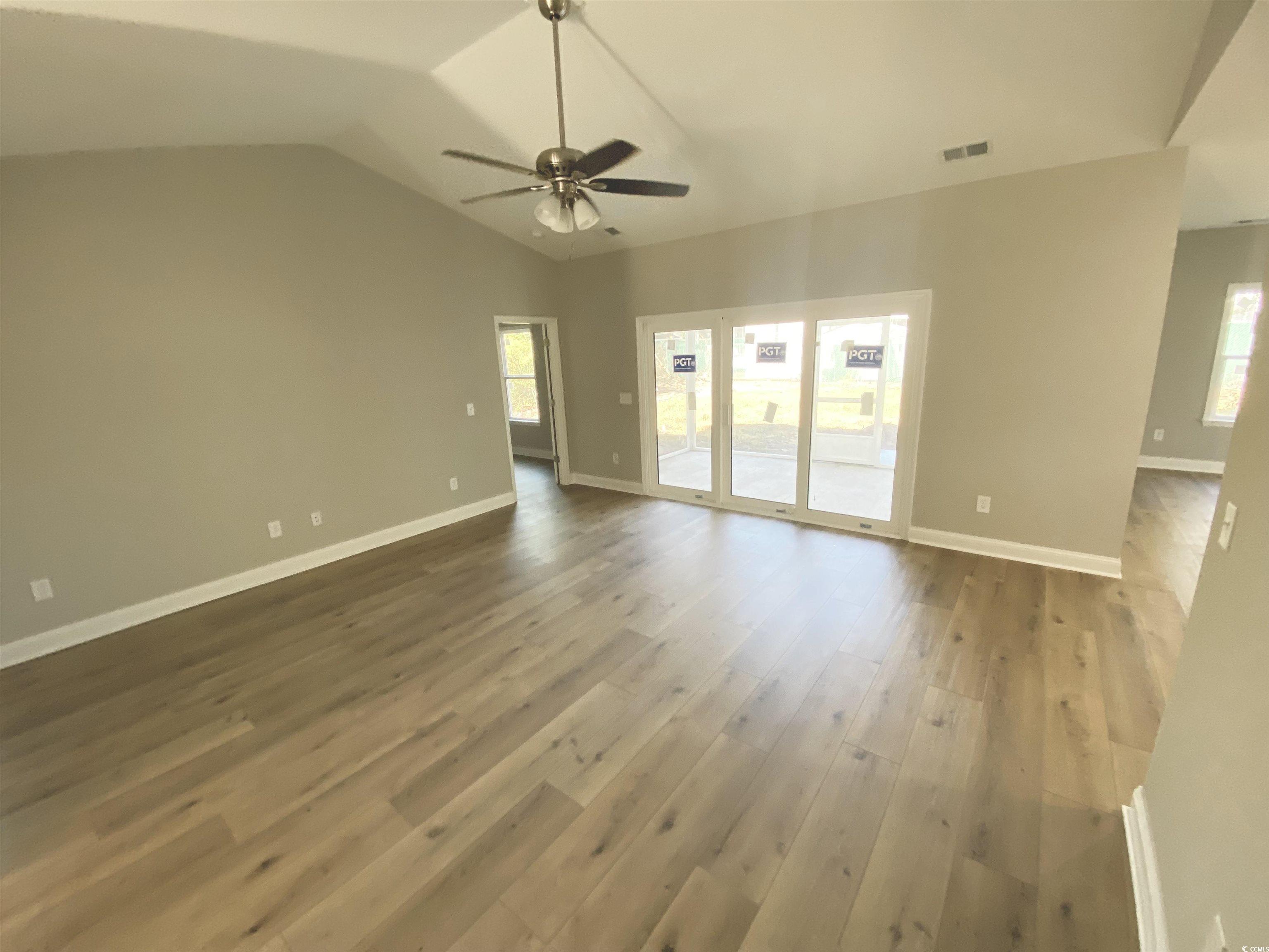 348 Jay Street Murrells Inlet, SC 29576 - Photo 11 of 29 Unfurnished living room with ceiling fan, vaulted