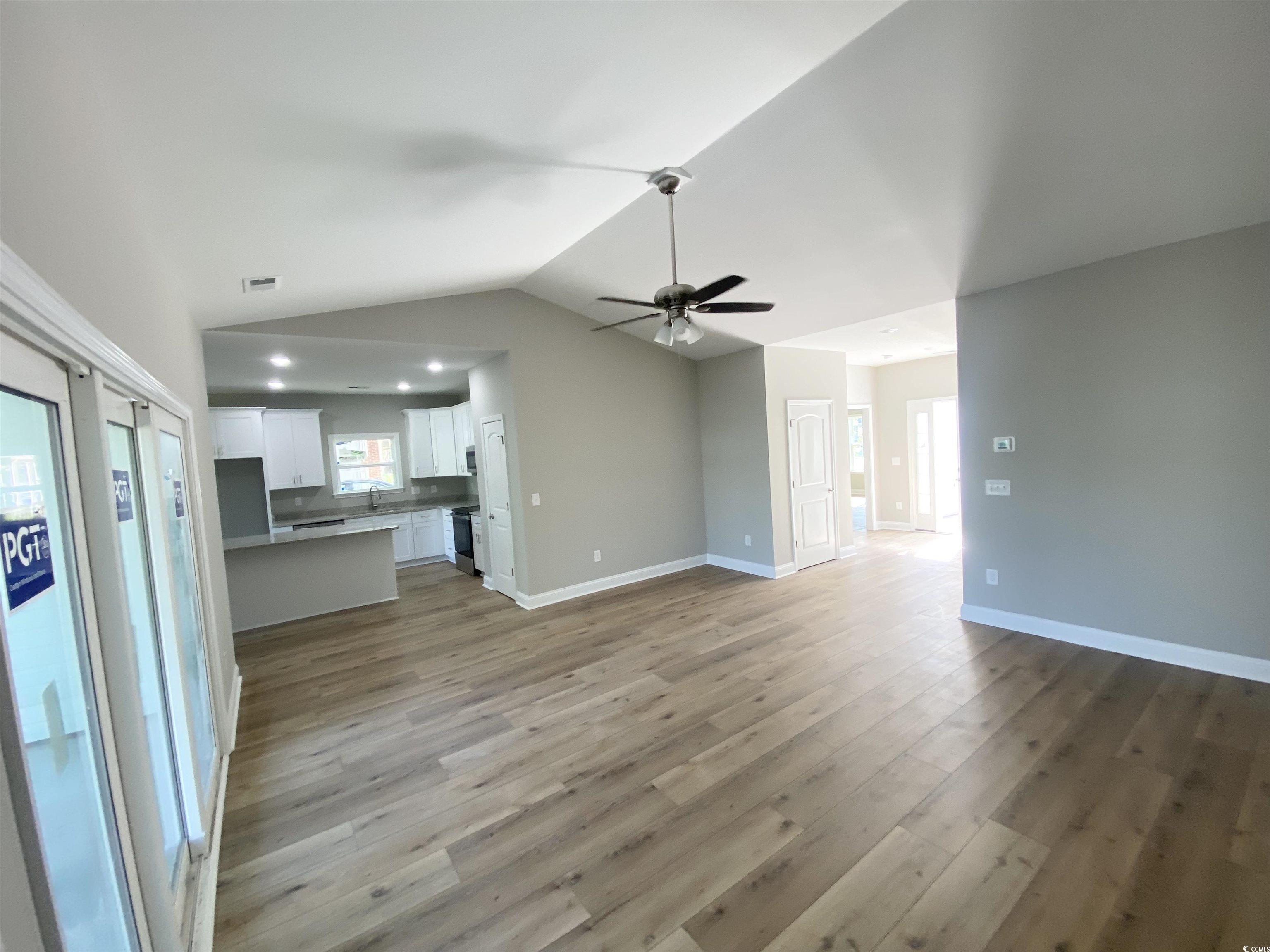 348 Jay Street Murrells Inlet, SC 29576 - Photo 13 of 29 Unfurnished living room with lofted ceiling, sink,