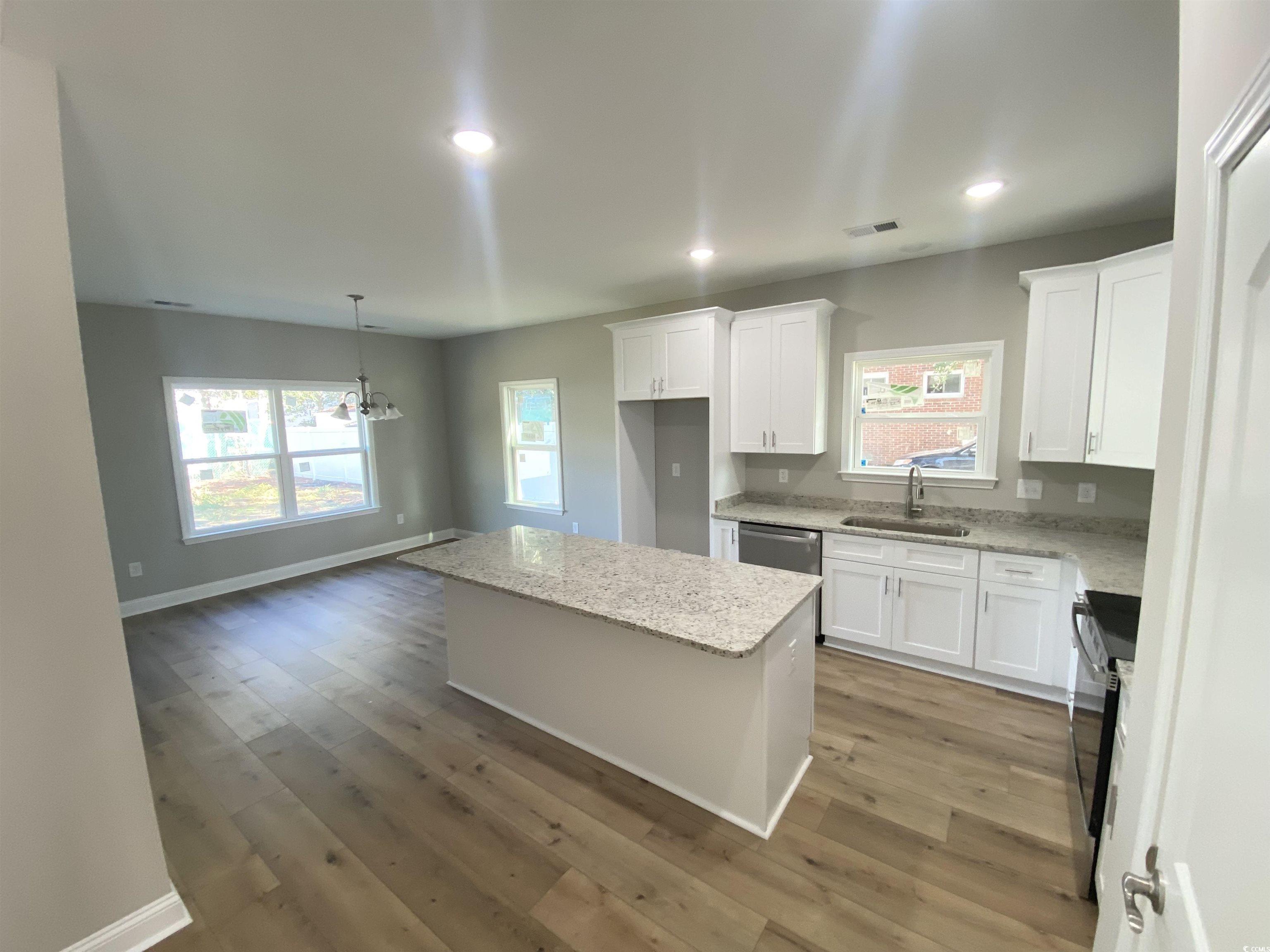 348 Jay Street Murrells Inlet, SC 29576 - Photo 3 of 29 Kitchen with sink, a center island, hardwood / woo