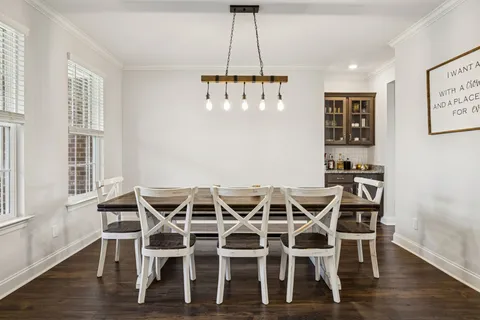 a dining room with wooden floor and a window