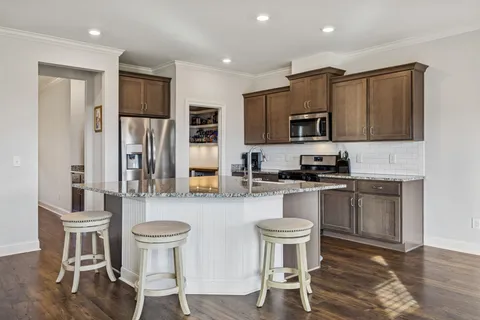 a kitchen with granite countertop a stove and a sink