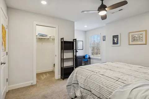 a bedroom with a bed and a dresser in it