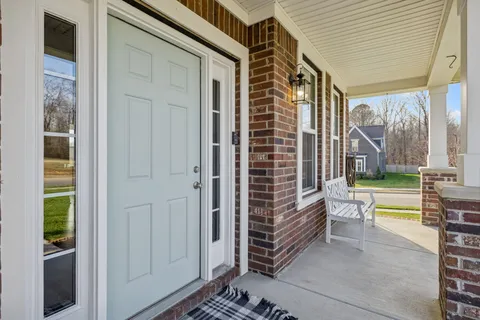 a view of a livingroom with wooden floor and furniture