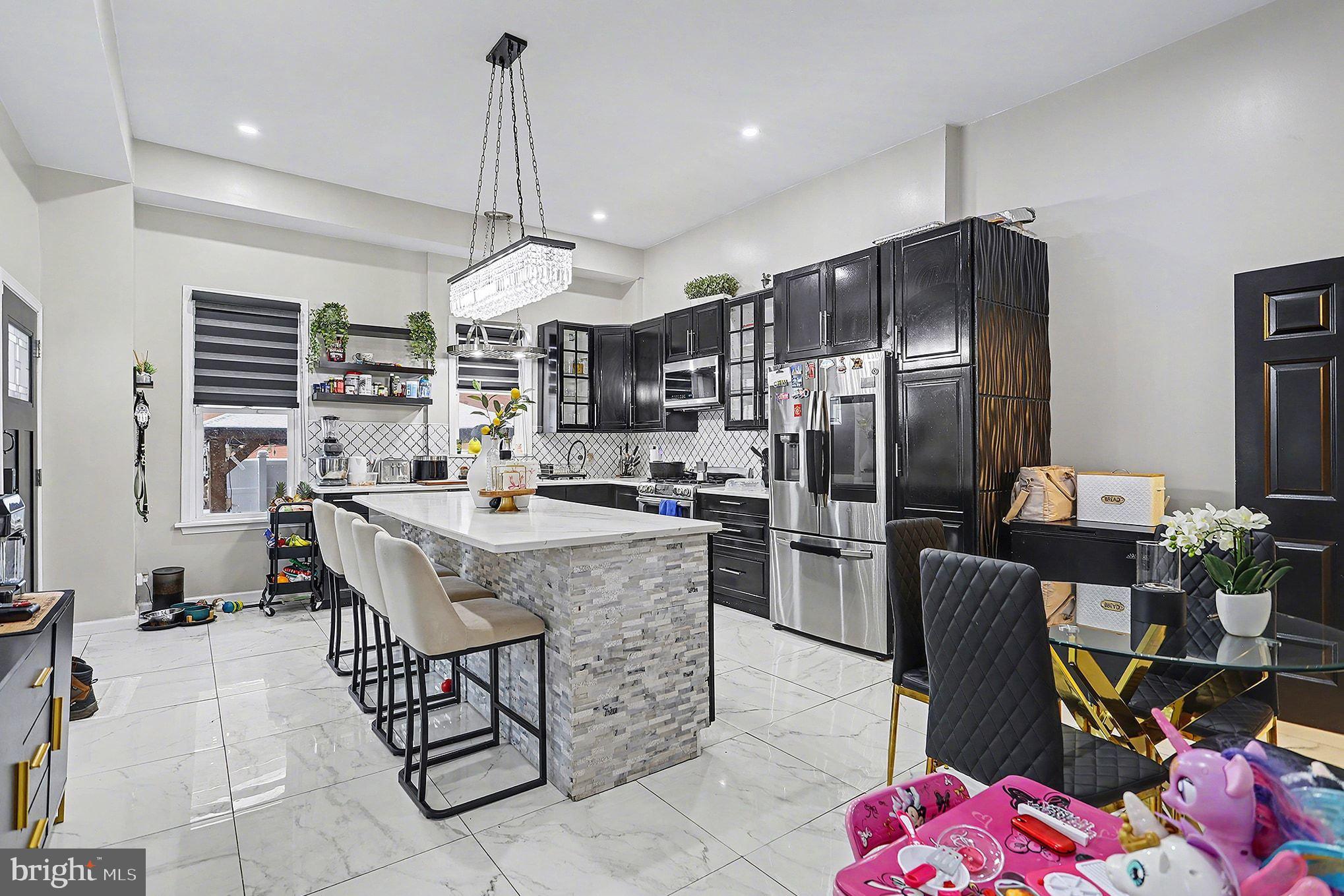 669 West Princess Street York, PA 17401 - Photo 11 of 33 a kitchen with a chandelier a refrigerator and a stove