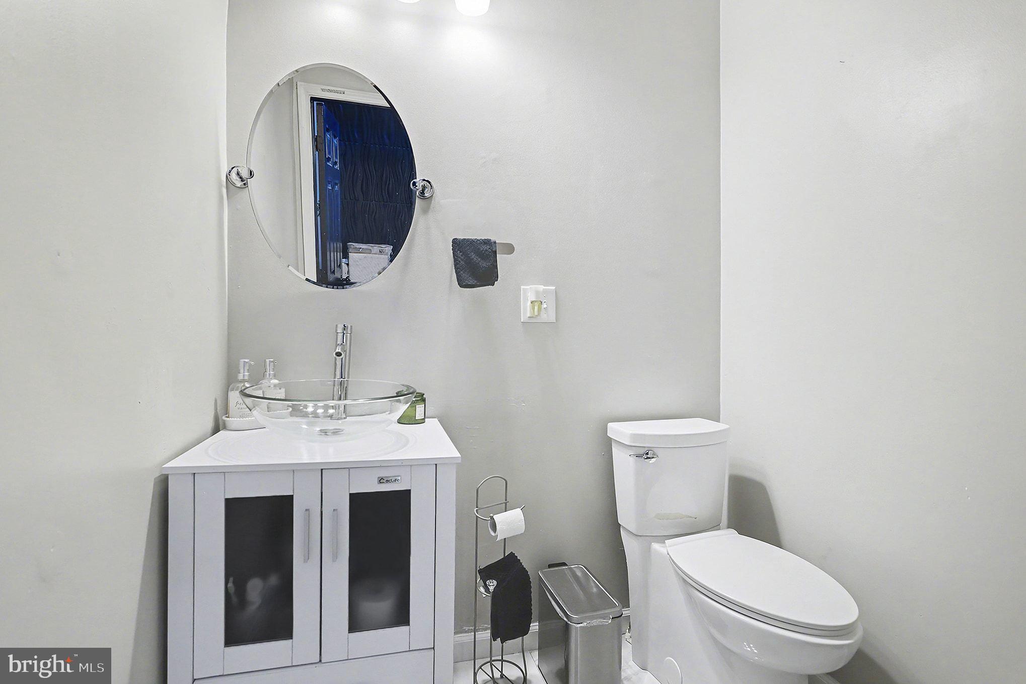 669 West Princess Street York, PA 17401 - Photo 12 of 33 a bathroom with a toilet sink and mirror