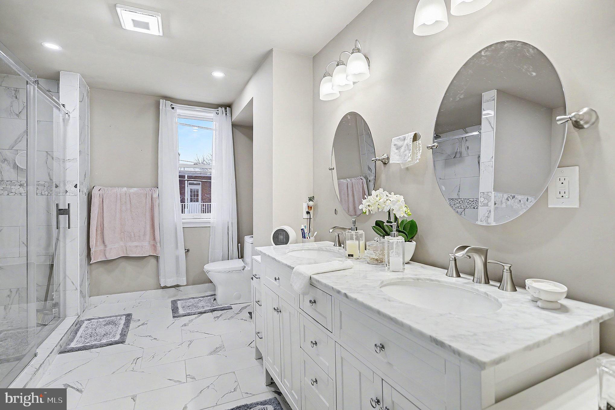 669 West Princess Street York, PA 17401 - Photo 21 of 33 a spacious bathroom with a double vanity sink mirror and shower