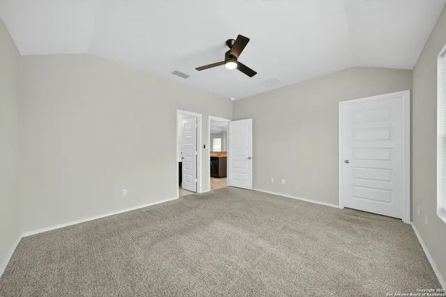 a view of empty room with ceiling fan
