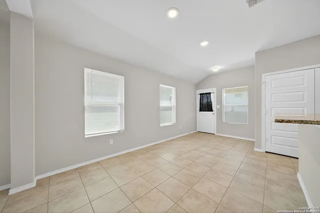 an empty room with windows and closet