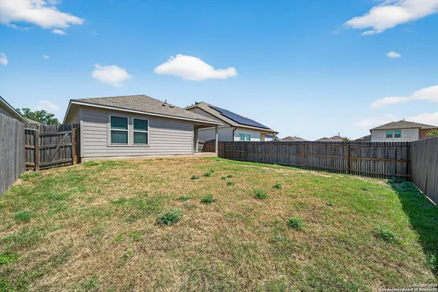 a view of a house with wooden fence