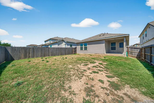 a view of a house with a backyard