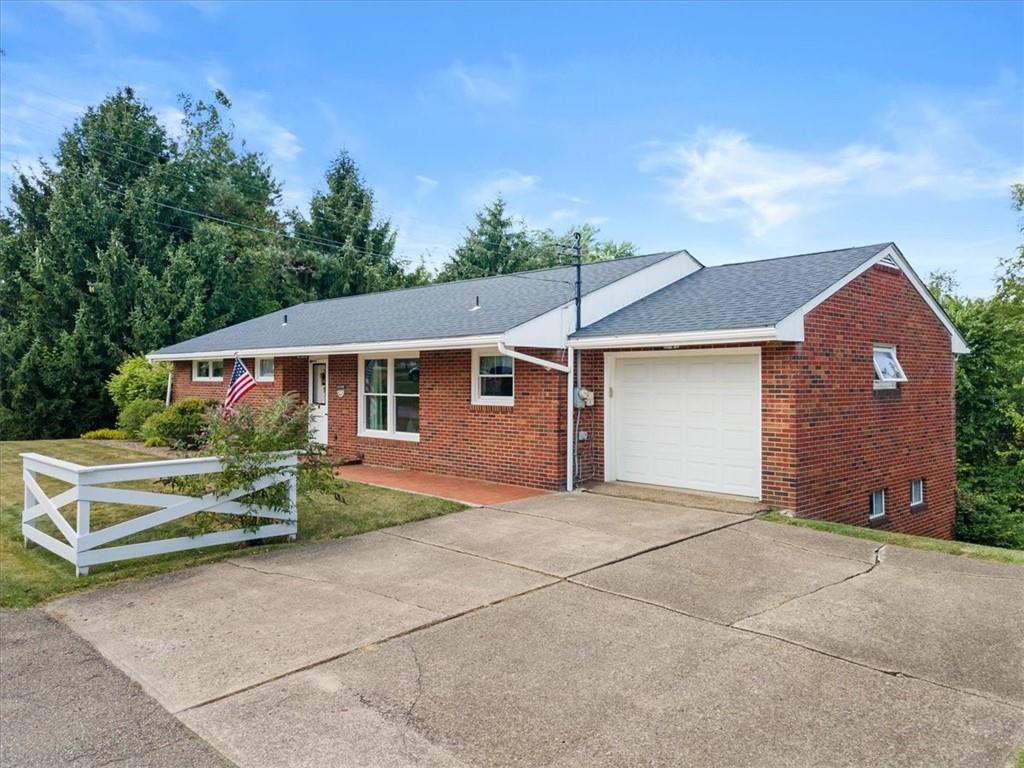1891 Concord Drive Ambridge, PA 15003 - Photo 5 of 40 a front view of a house with a yard and garage