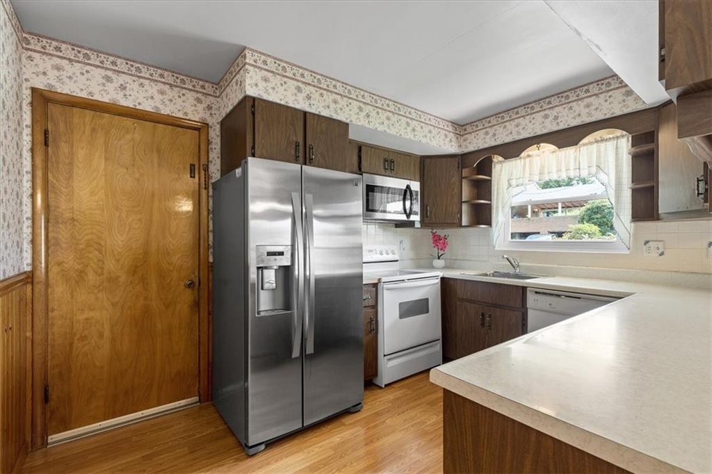 1891 Concord Drive Ambridge, PA 15003 - Photo 8 of 40 a kitchen with stainless steel appliances a refrigerator sink and stove