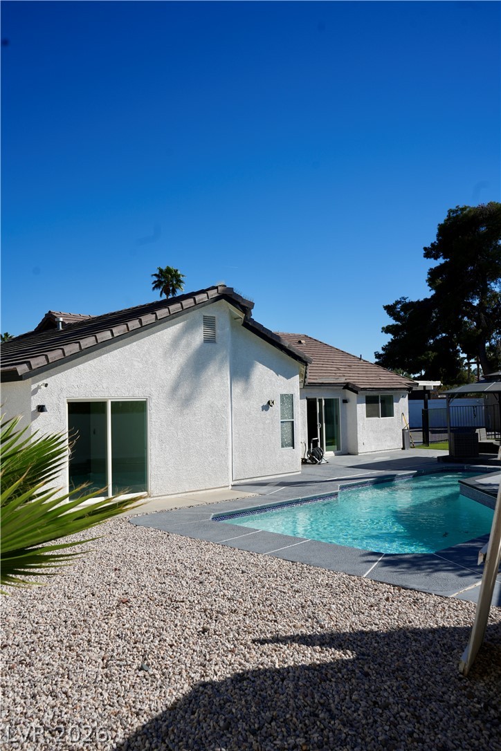 2351 Valleywood Road Henderson, NV 89014 - Photo 30 of 43 Back of property featuring a patio area, stucco siding, and a tile roof