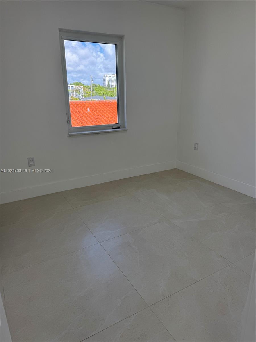 3305 Southwest 28th Street, Unit 3305 Miami, FL 33133 - Photo 12 of 17 an empty room with a window