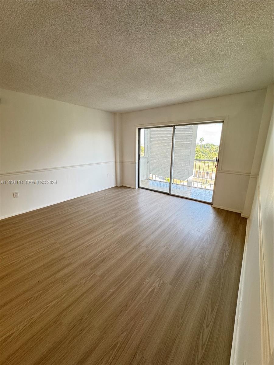 4160 Inverrary Drive, Unit 510 Lauderhill, FL 33319 - Photo 11 of 25 an empty room with wooden floor and windows