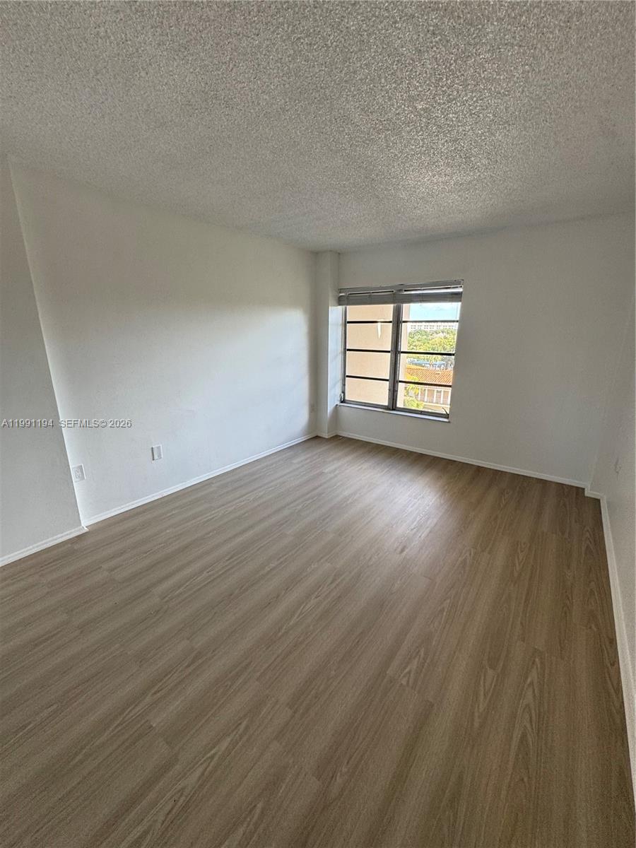 4160 Inverrary Drive, Unit 510 Lauderhill, FL 33319 - Photo 12 of 25 an empty room with wooden floor and windows