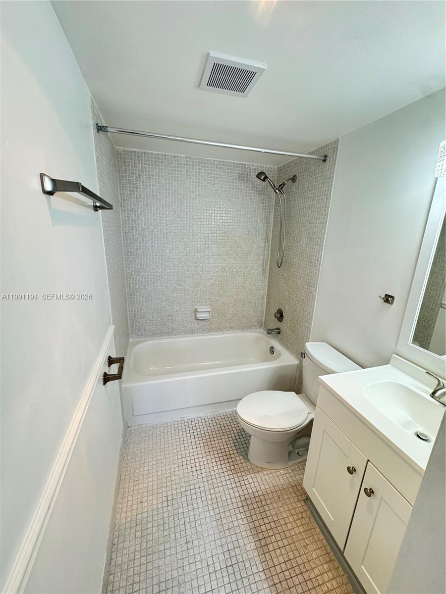 4160 Inverrary Drive, Unit 510 Lauderhill, FL 33319 - Photo 17 of 25 a bathroom with a sink a toilet and a bathtub