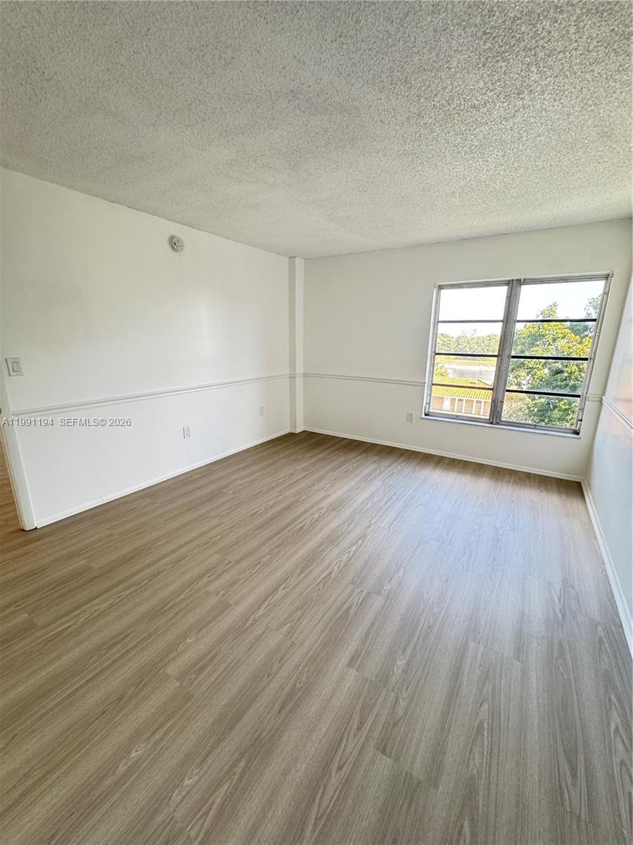 4160 Inverrary Drive, Unit 510 Lauderhill, FL 33319 - Photo 20 of 25 an empty room with wooden floor and windows