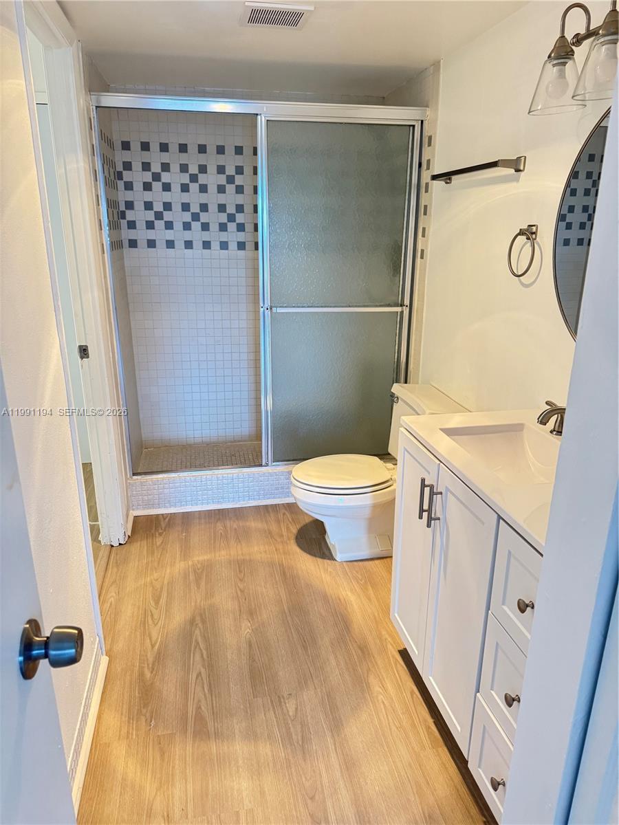 4160 Inverrary Drive, Unit 510 Lauderhill, FL 33319 - Photo 22 of 25 a bathroom with a sink a toilet a mirror and shower