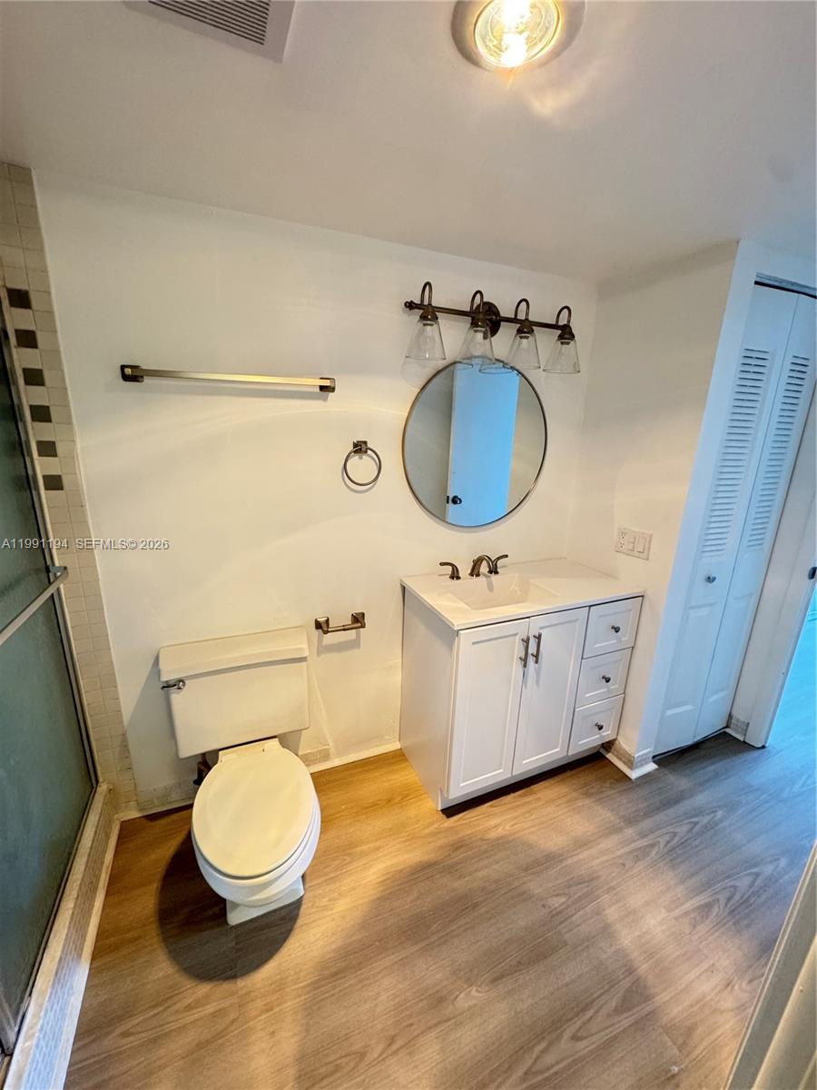 4160 Inverrary Drive, Unit 510 Lauderhill, FL 33319 - Photo 23 of 25 a bathroom with a granite countertop toilet sink and mirror