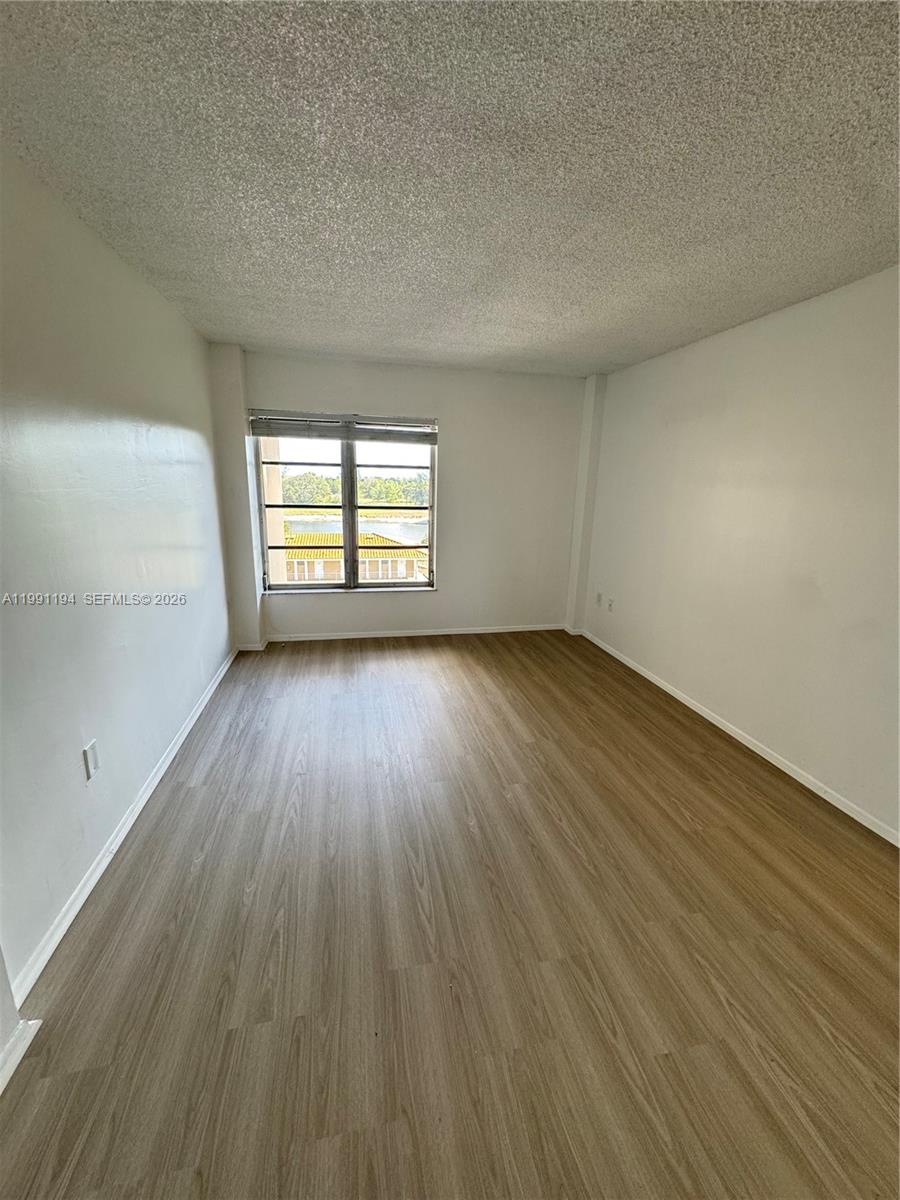 4160 Inverrary Drive, Unit 510 Lauderhill, FL 33319 - Photo 25 of 25 an empty room with wooden floor and windows