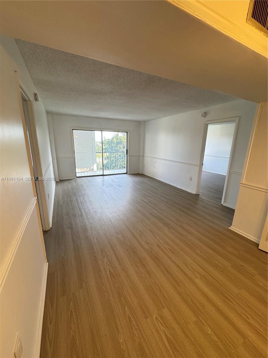 4160 Inverrary Drive, Unit 510 Lauderhill, FL 33319 - Photo 8 of 25 wooden floor in an empty room with a window