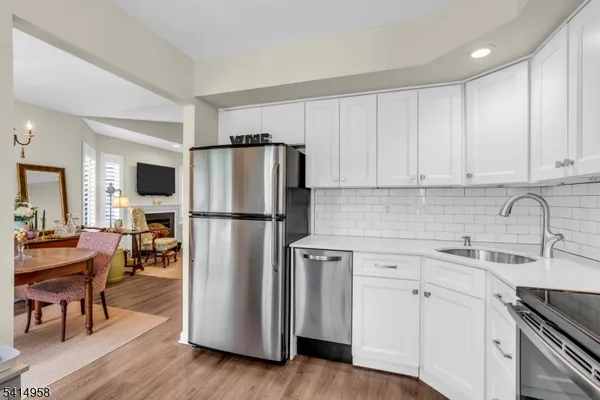 a kitchen with stainless steel appliances a refrigerator sink and cabinets