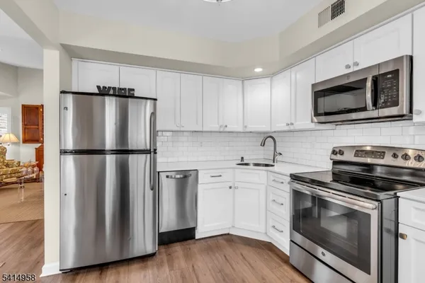 a kitchen with a stove microwave and a refrigerator