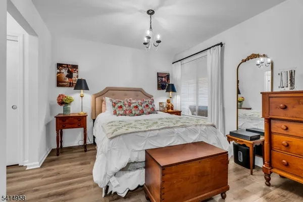 a bedroom with a bed and a dresser in it
